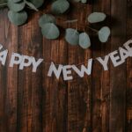 Happy New year banner on table with greens